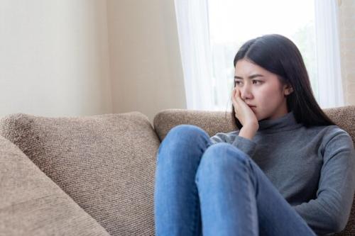 close-up-face-unhappy-asian-pretty-young-woman-sitting-alone-couch-with-feeling-sadness-928174-1989_1700405068.jpg